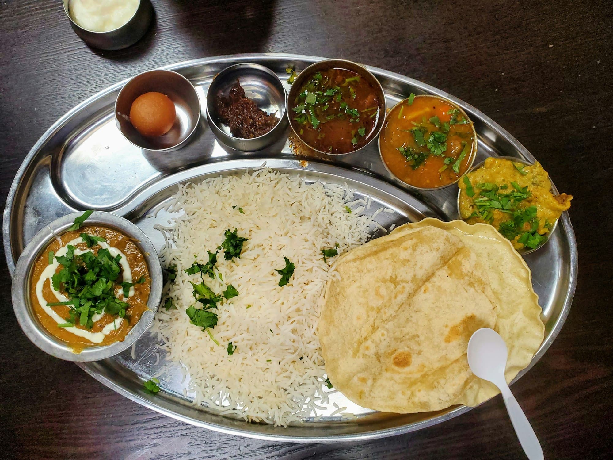 An Indian thali — rice, curries, dal and freshly made papad
